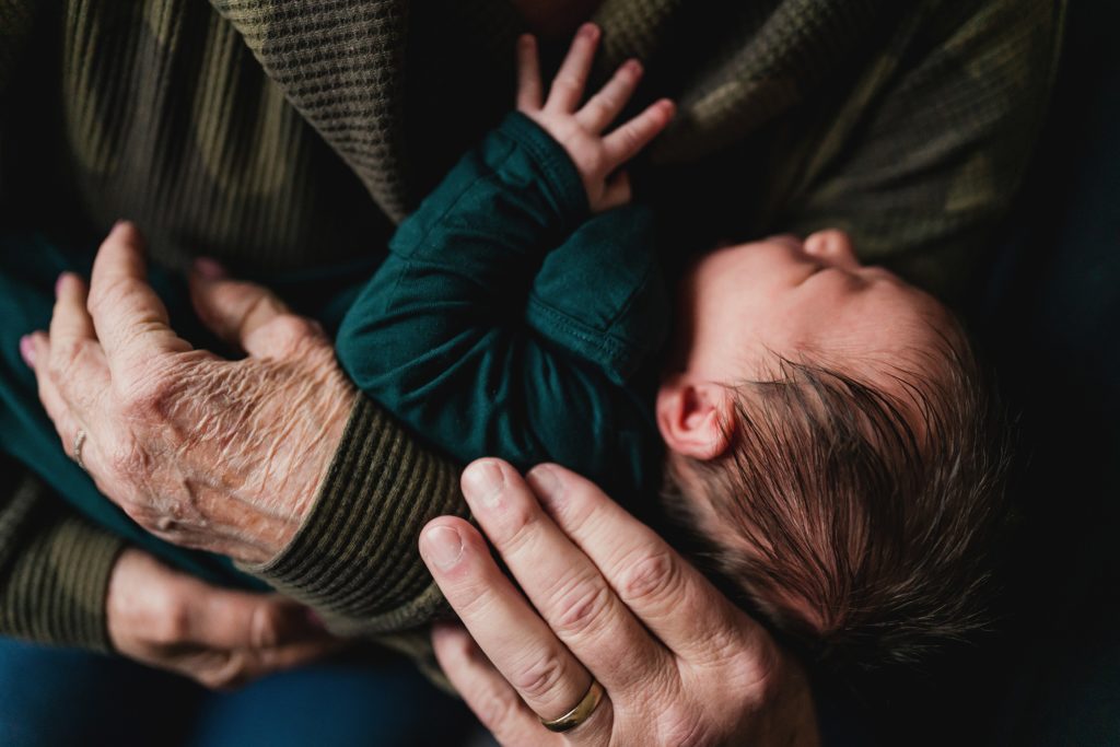 newborn photo of baby boy in grandparents arms