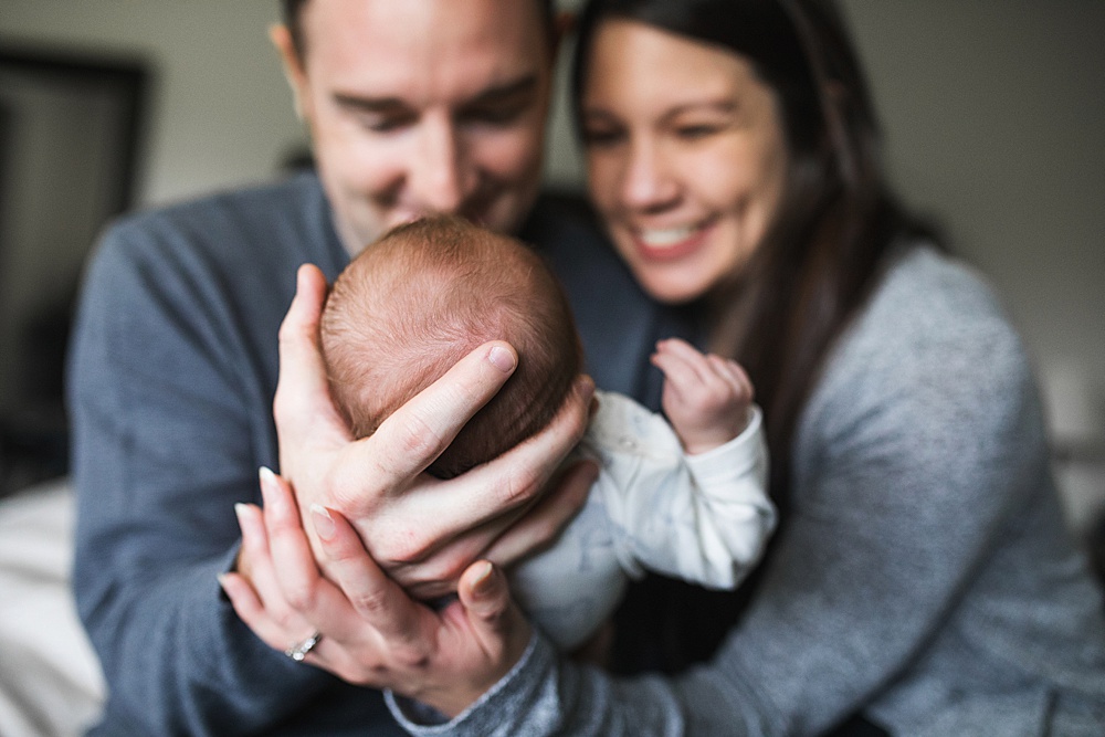 parents admiring newborn baby during Seattle newborn photo session