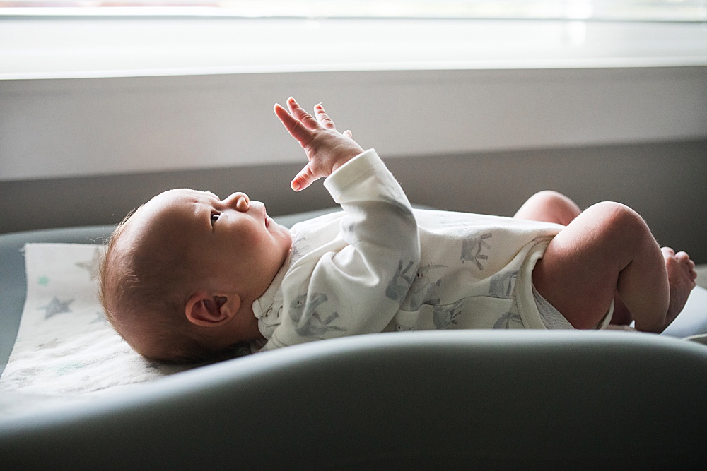 Newborn baby on changing pad