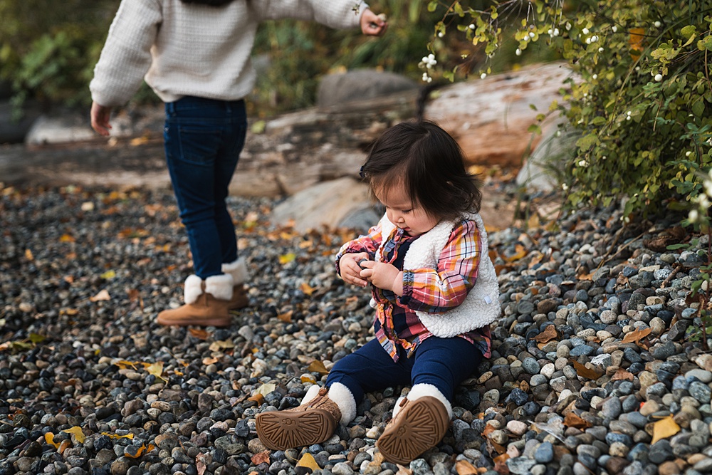 photo of toddler girl in rocks by the water