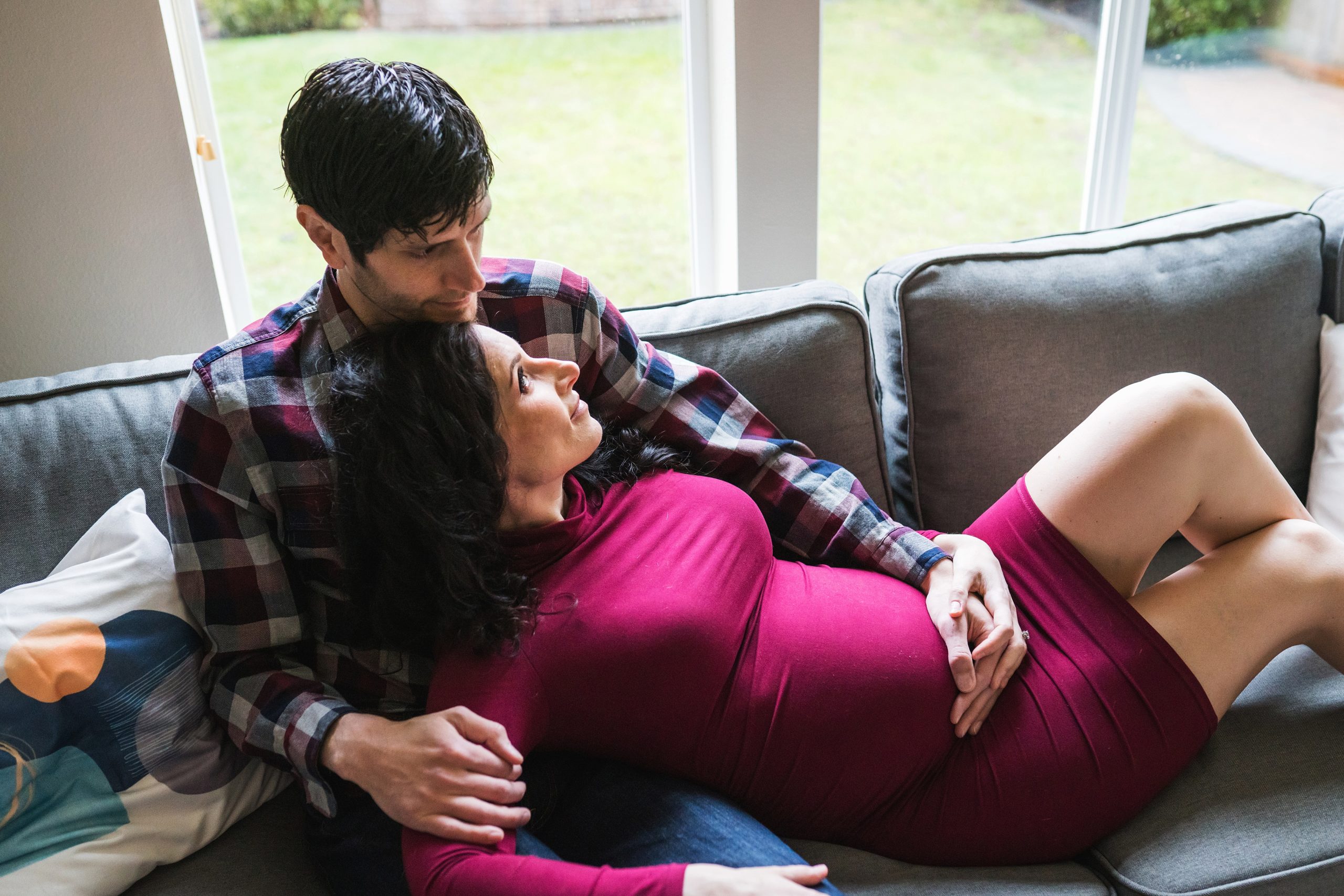 Seattle area In home maternity shoot, husband and pregnant wife together on couch