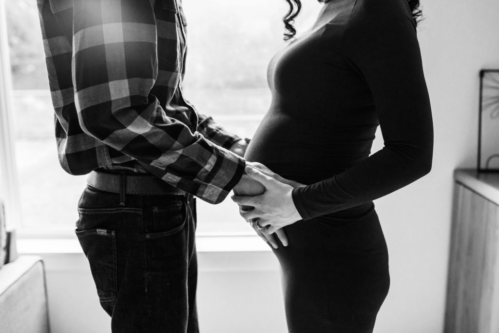 Seattle in home maternity shoot, black and white photo of husband and wife with baby bump