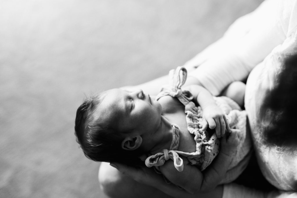 black and white newborn photo of newborn in mom's arms during Seattle newborn photo session