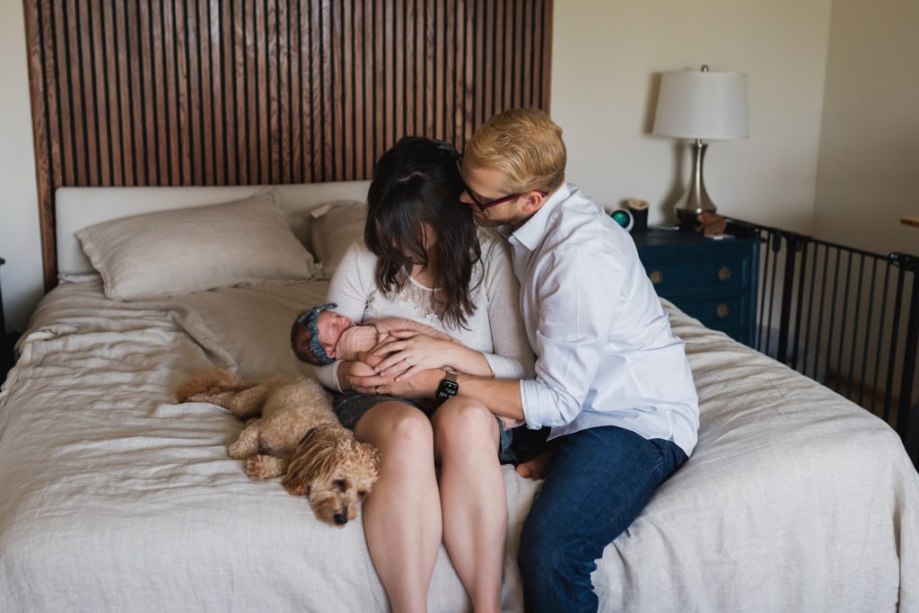 Favorite poses for newborn photos with family and dog on the master bed together