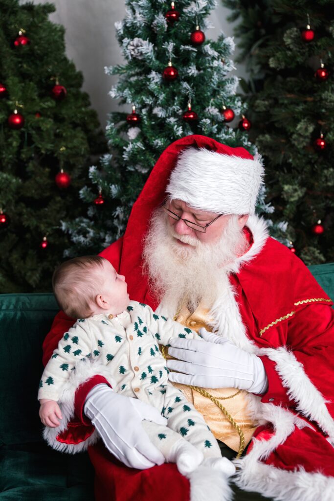 Baby looking at Santa during Santa portrait session