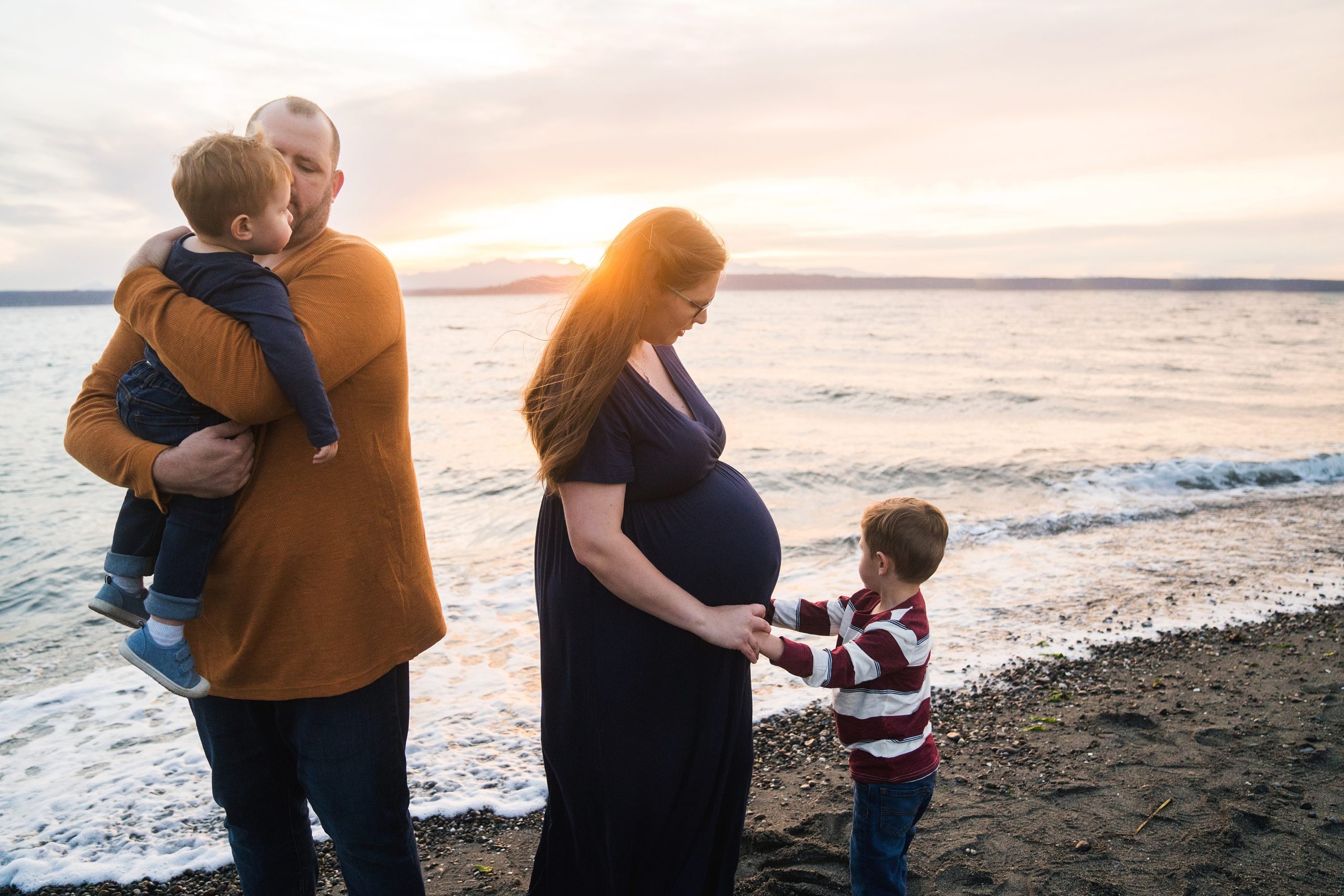Family of four playing at the beach during Seattle maternity photos