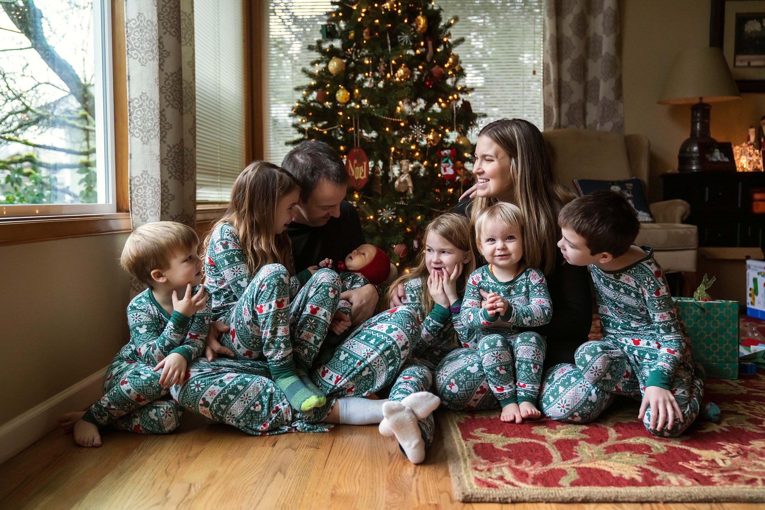 Christmas tradition of family of 8 in matching Christmas pjs