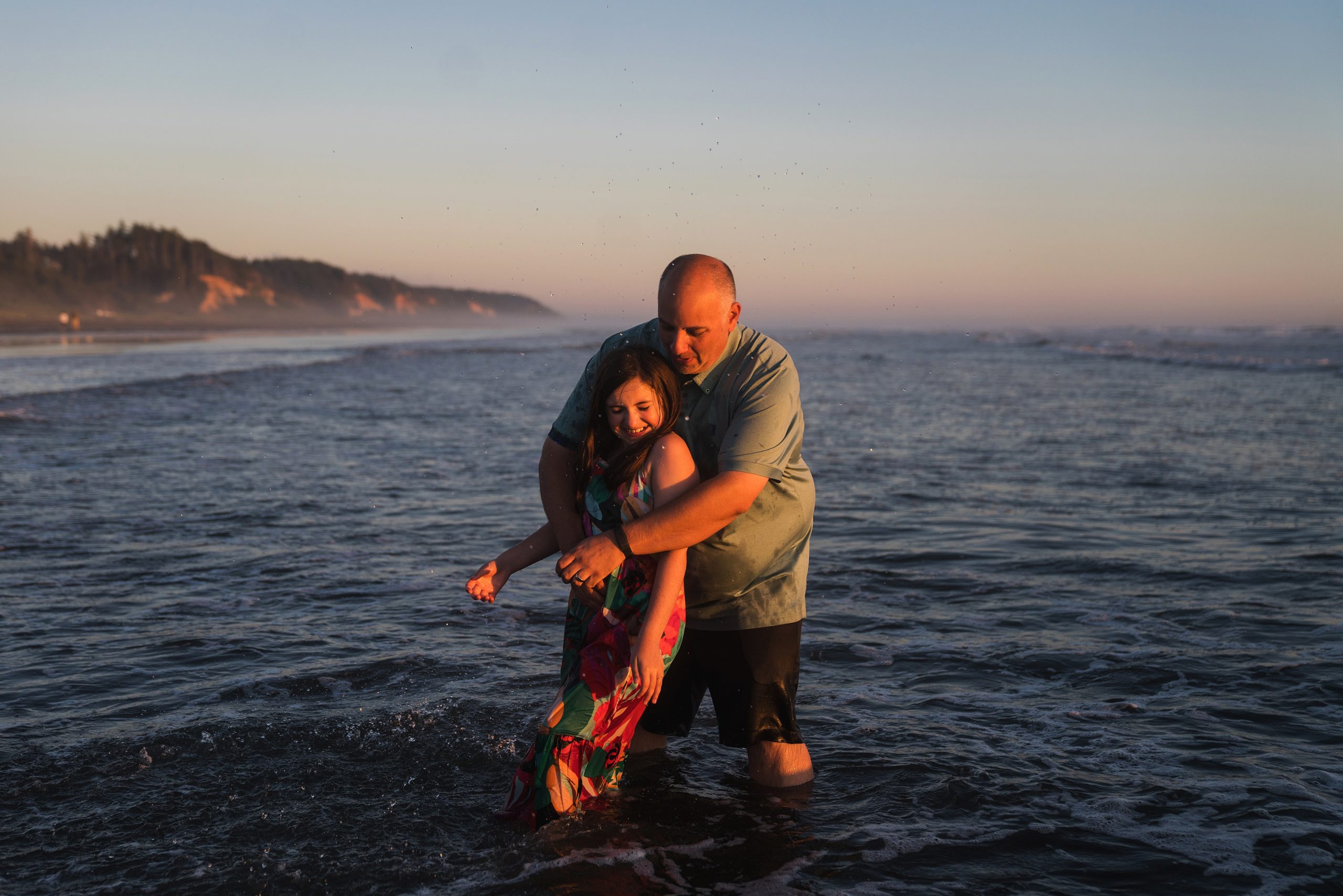 Father and daughter playing in the ocean