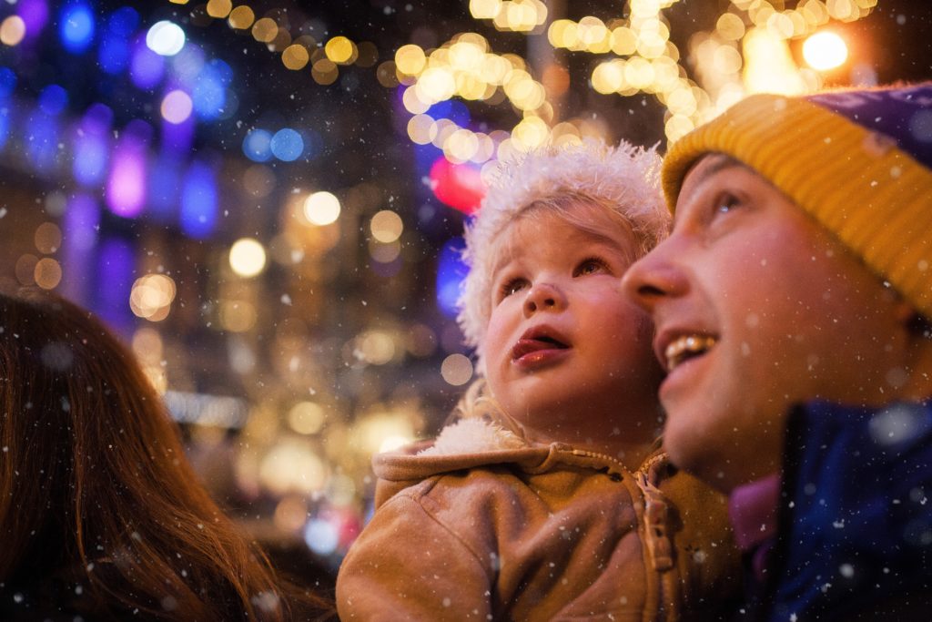 Father and daughter at Snowflake Lane looking at Christmas lights 