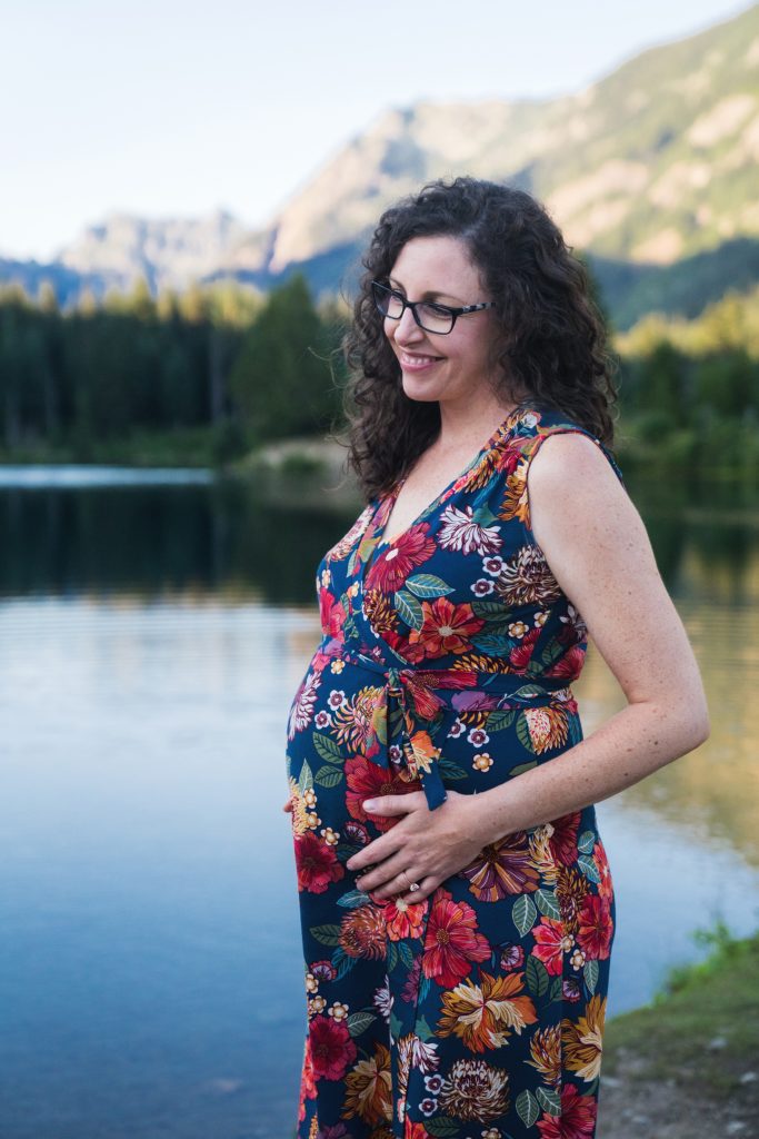 Woman holding belly during Gold Creek Pond Pregnancy session