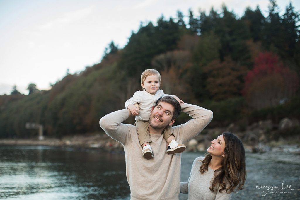 Dad with son on shoulders and mom smiling during Carkeek Park family photos