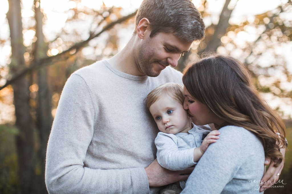 Mother and father snuggle baby during lifestyle family photos