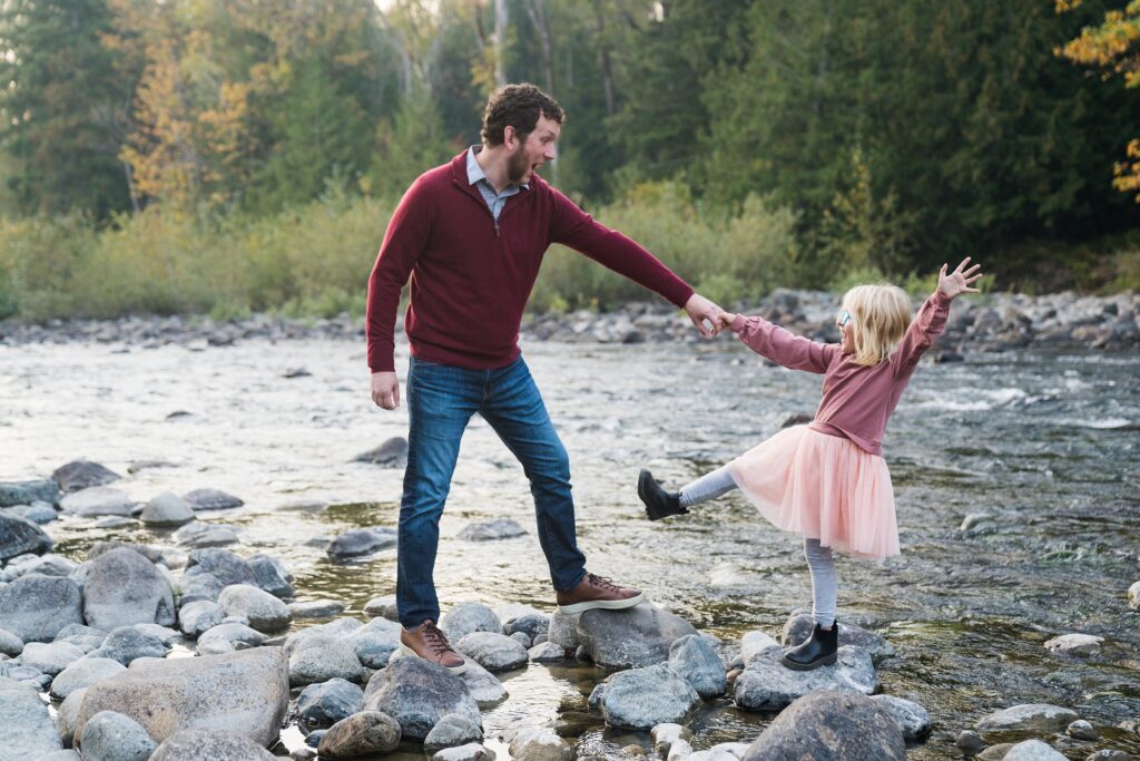 Father and daughter playing at the river in North Bend, Wa