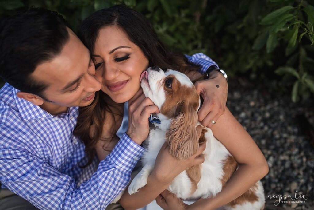 Family loving on Cavalier King Charles Spaniel during Seattle family photo session
