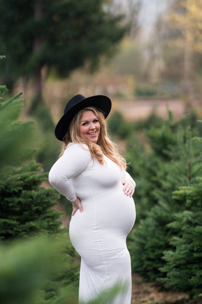 Expecting mama for outdoor maternity photos in a gorgeous white maxi dress