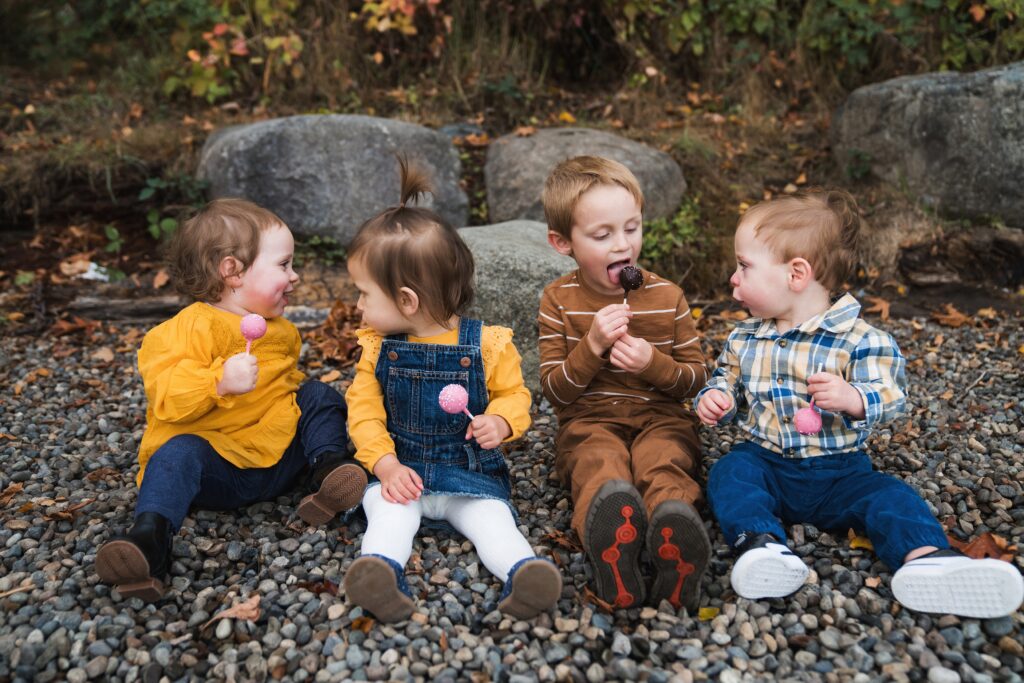 Professional picture of toddler cousins together enjoying a cake pop
