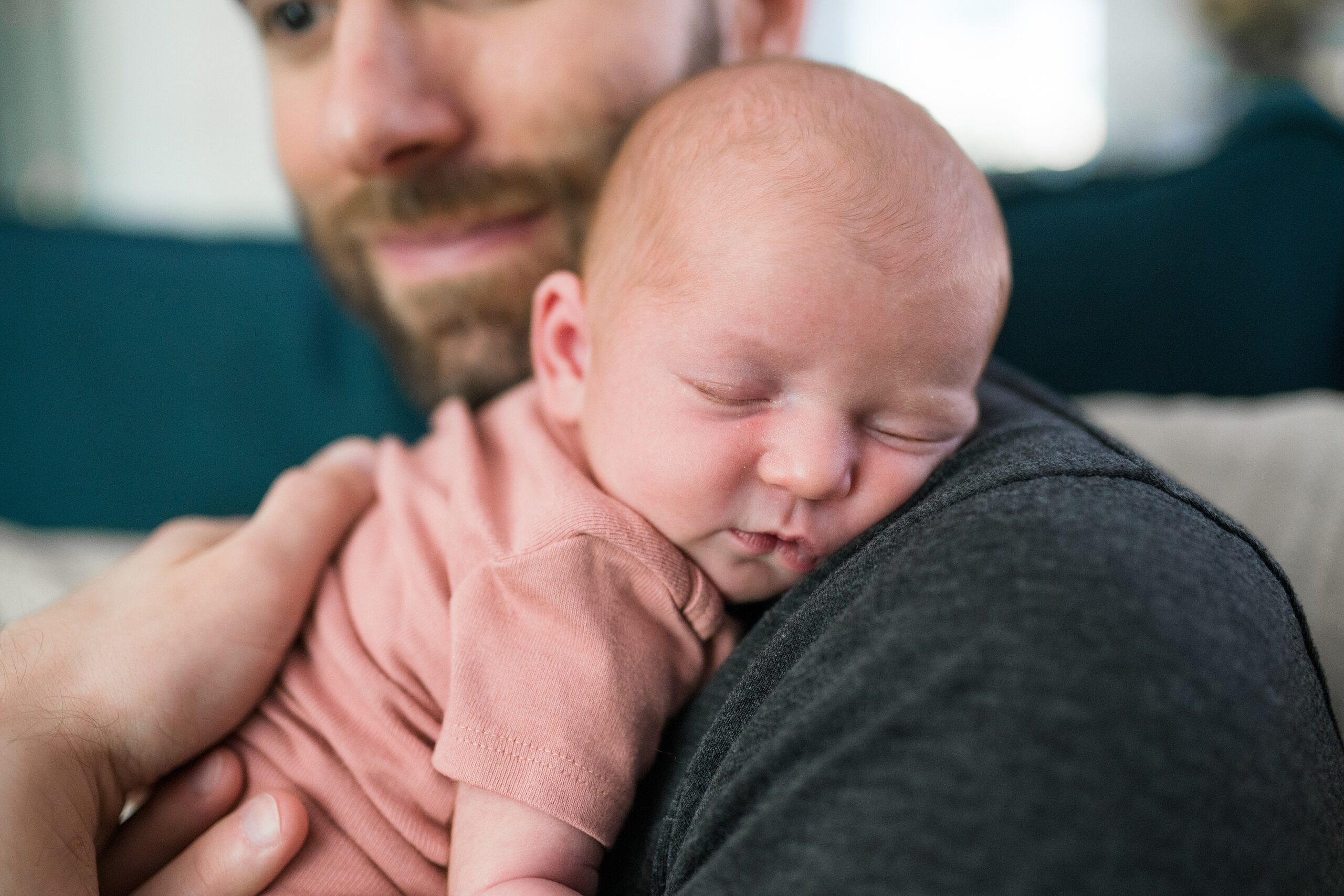 Newborn baby girl against dads shoulder during professional Seattle area newborn photos