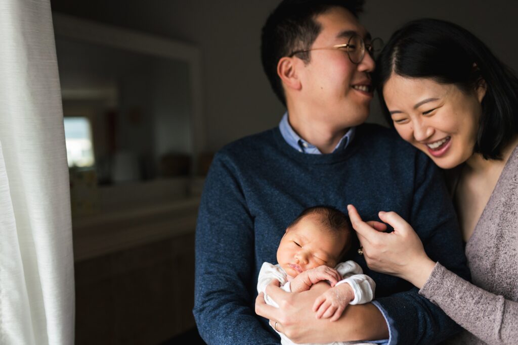Family in neutrals and navy outfits for newborn photo shoot in Seattle area