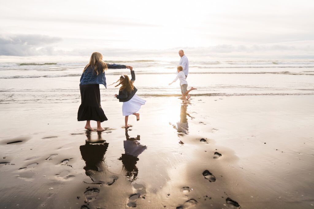 Family playing in the waves at Ocean Shores during family photo session