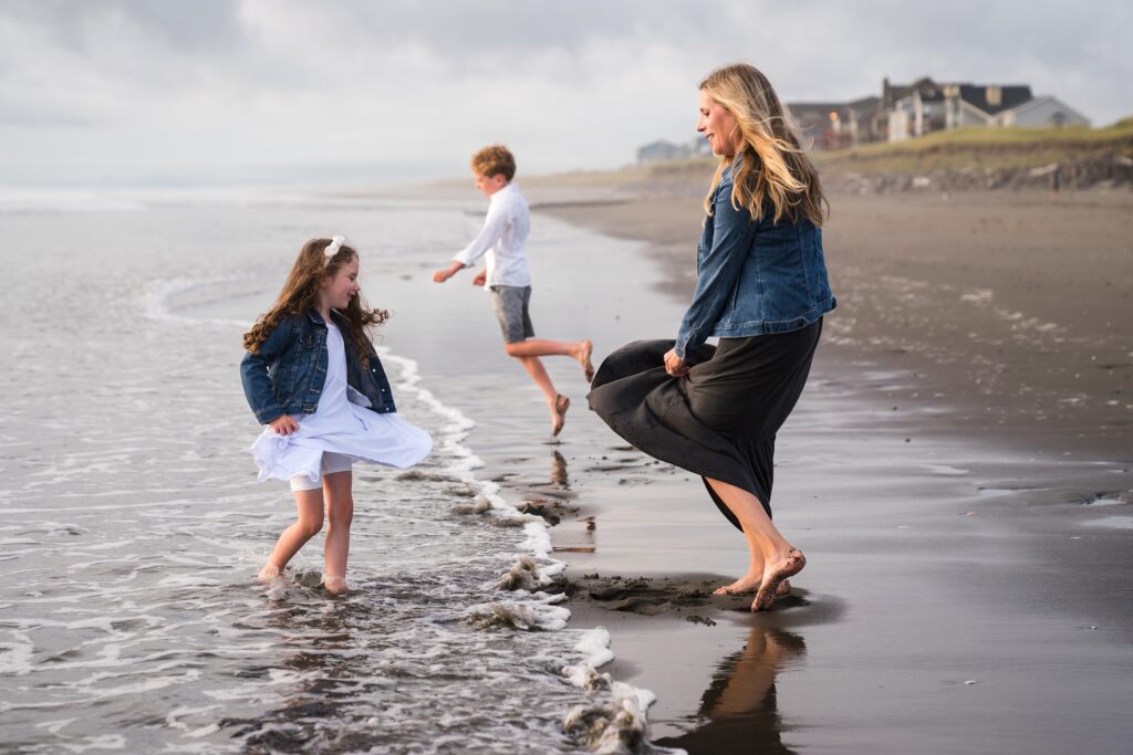 Mother and daughter dancing in the waves at the Washington Coast, North Jetty Beach