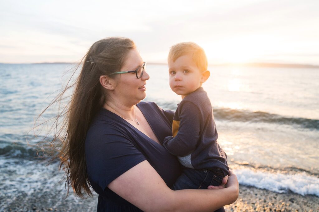 Mother and son at sunset  at the beach in Seattle for maternity photos