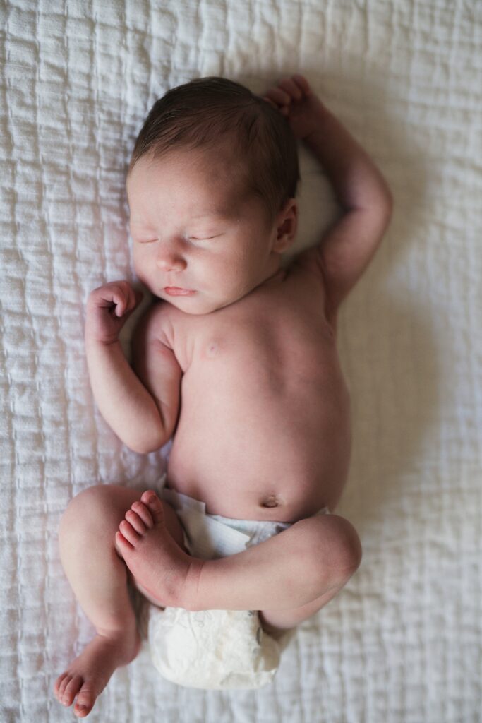 Baby girl sleeping in a diaper during Seattle newborn photos