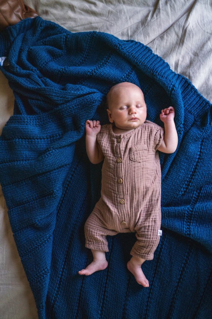 Newborn baby photo on a blue textured blanket