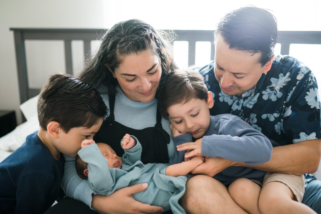 Family of five during Seattle in home lifestyle newborn portraits