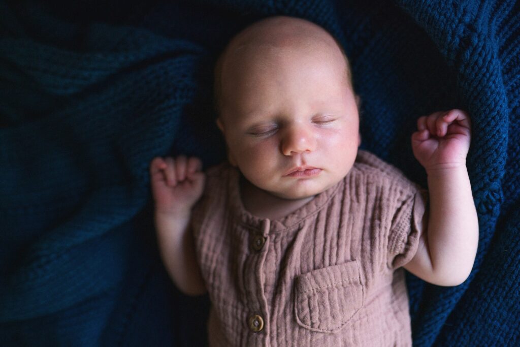 Lifestyle newborn portrait of baby on blanket 