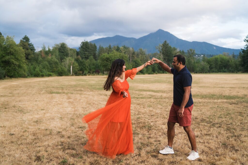 Couple dancing together in a field in the Snoqualmie Valley during a photo session