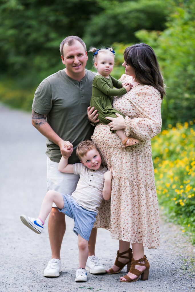 Family of four snuggled together for pregnancy portraits at Luther Burbank Park