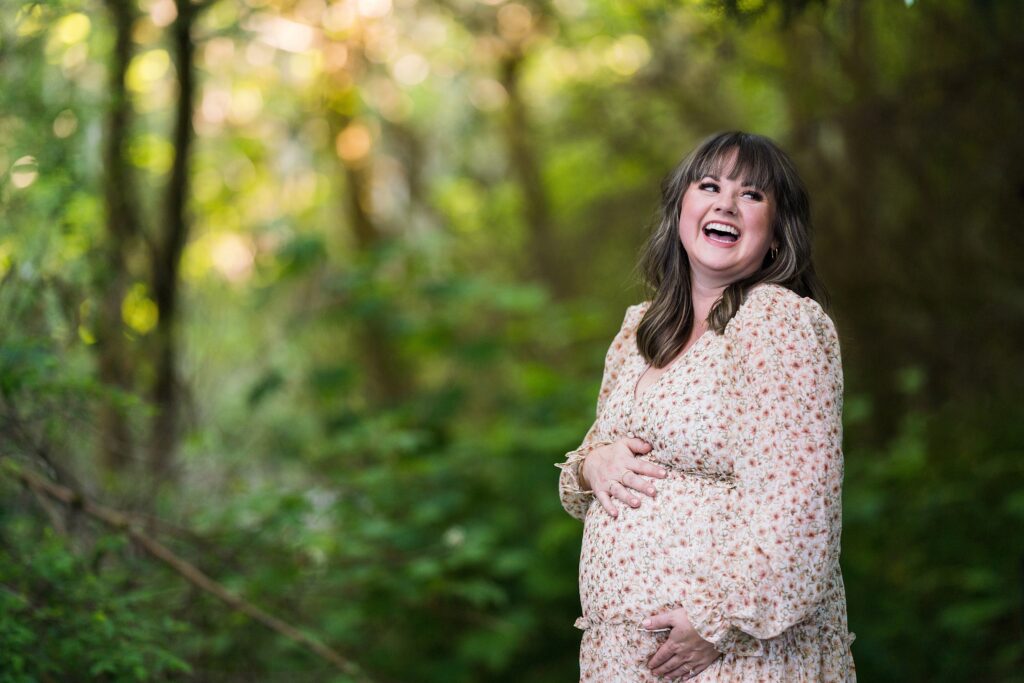 Expectant mother smiling  during Seattle portrait session