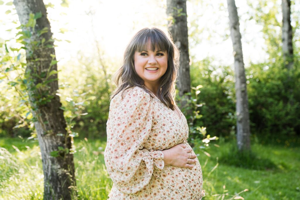 Spring maternity photos in the Seattle area, pregnancy pictures of mom smiling with glowing backlight