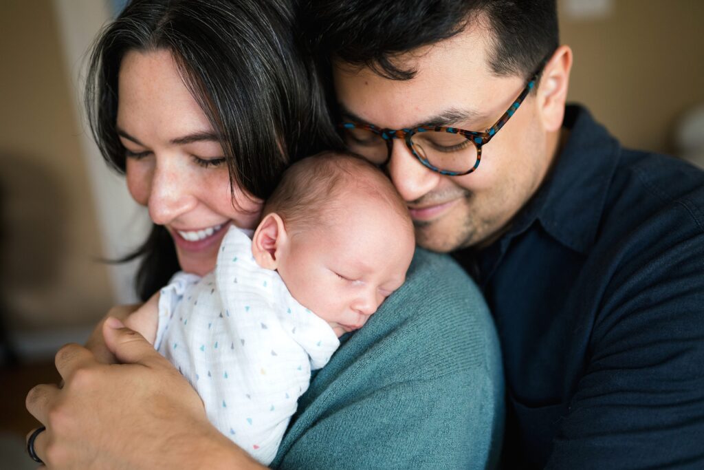 Seattle Lifestyle newborn portrait of mother holding baby and dad cuddling in close