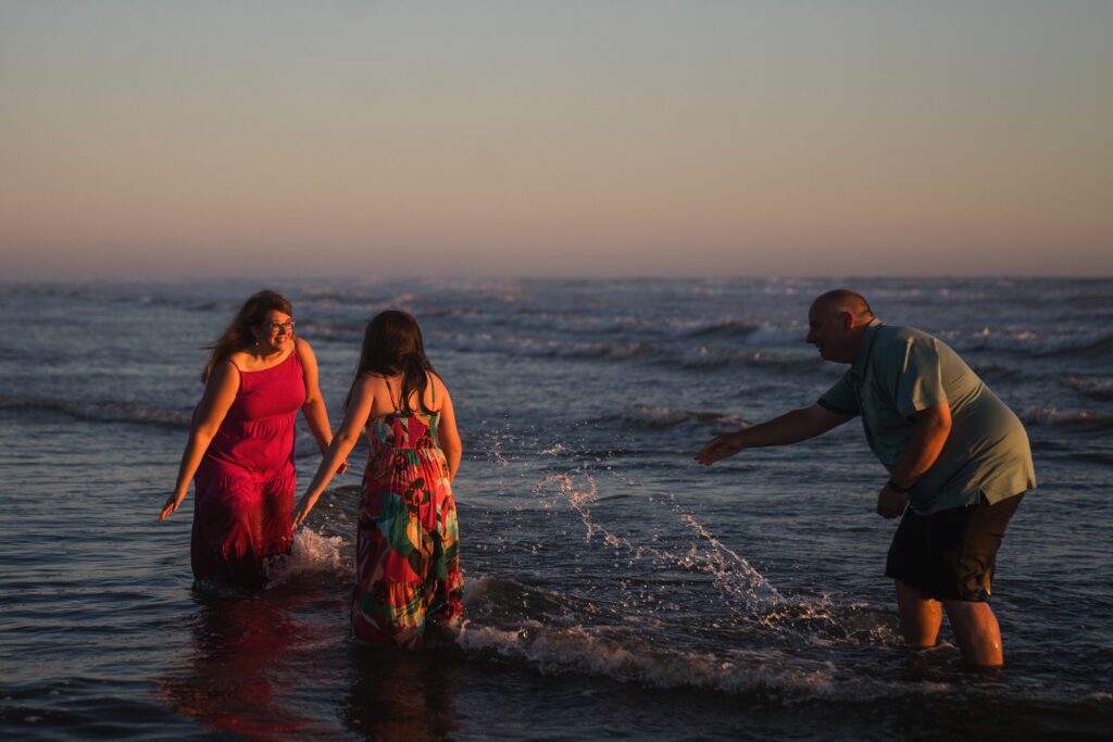 Family playing in the ocean during photo session at Seabrook, wa