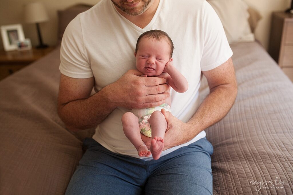 Father and newborn daugther during Seattle lifestyle portrait session