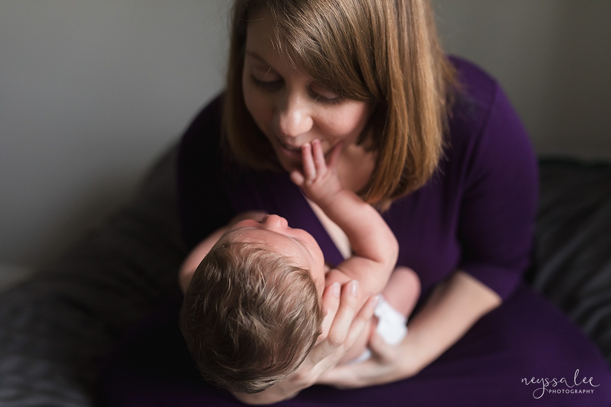 New Mom holding newborn baby girl during Seattle photo session, gift idea for Mother's Day