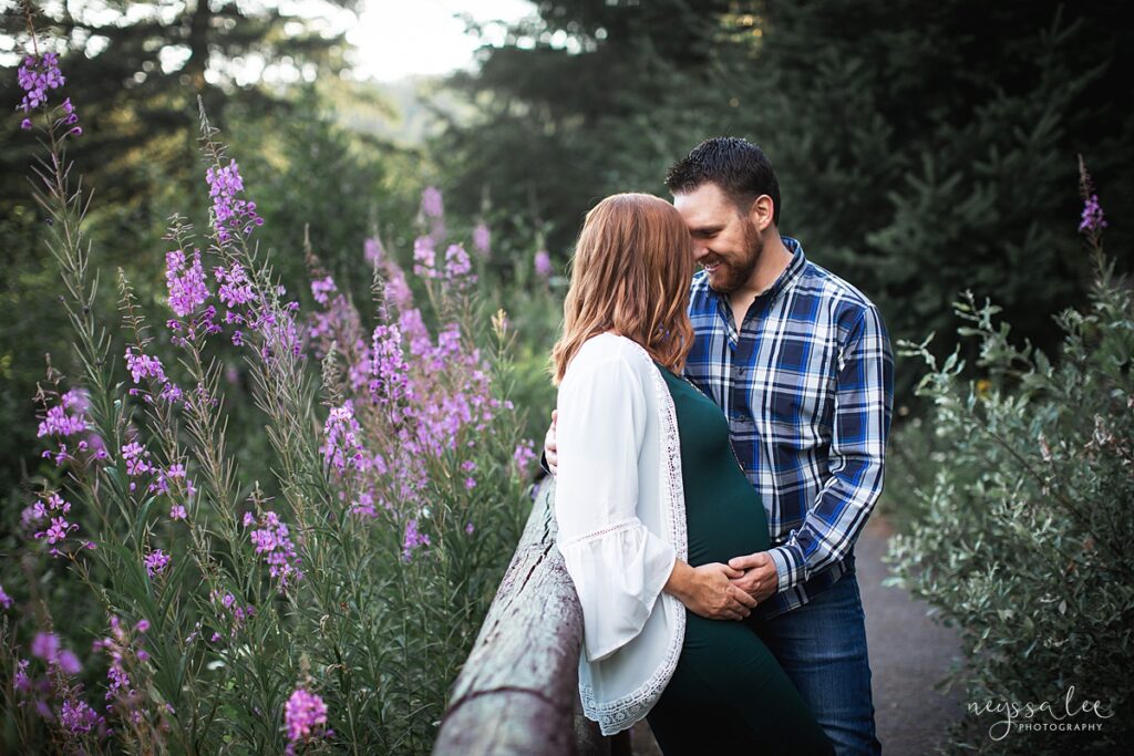 Couple for maternity portraits with wildflowers on Snoqualmie Pass