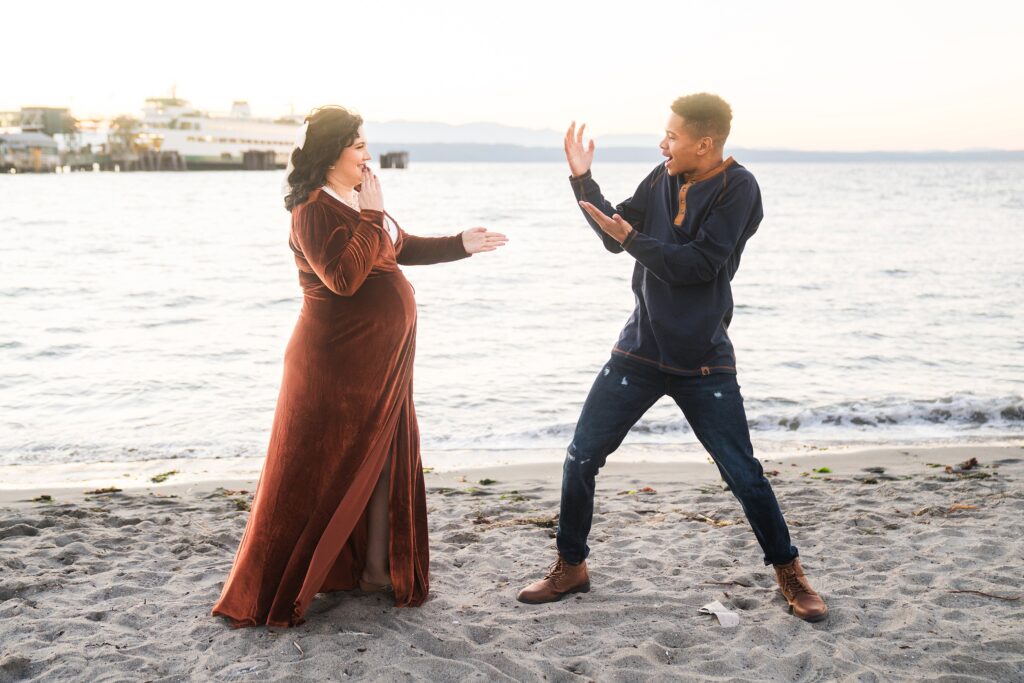 playful pregnancy photo of mother and son on Seattle beach