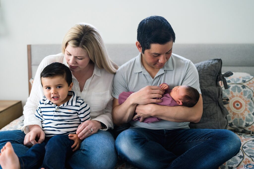 Family photos with a newborn including toddler brother and baby sister in Seattle home