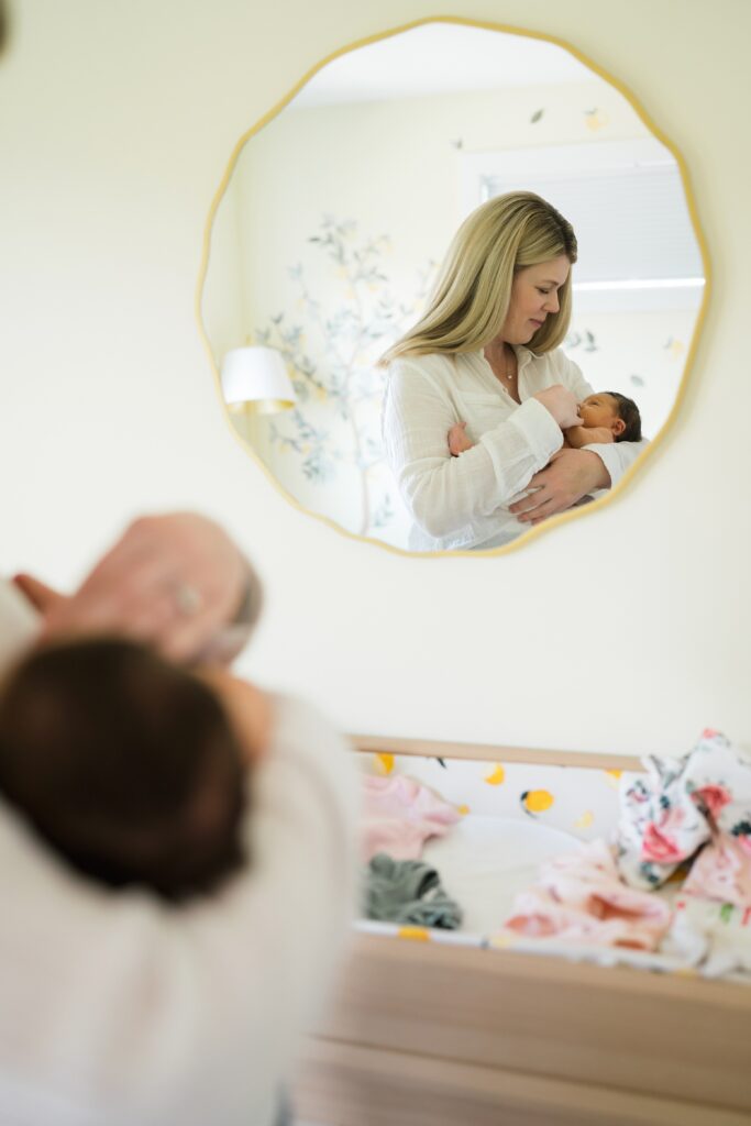 Photo of nursery mirror with mother and baby during baby photoshoot