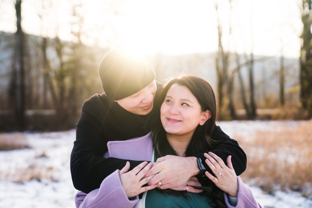 Couple snuggled together in winter photo session in Snoqualmie Valley