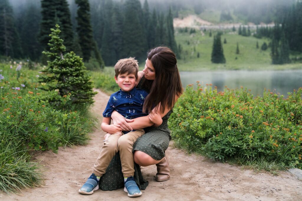 Mother hugging son near the water at Tipsoo Lake