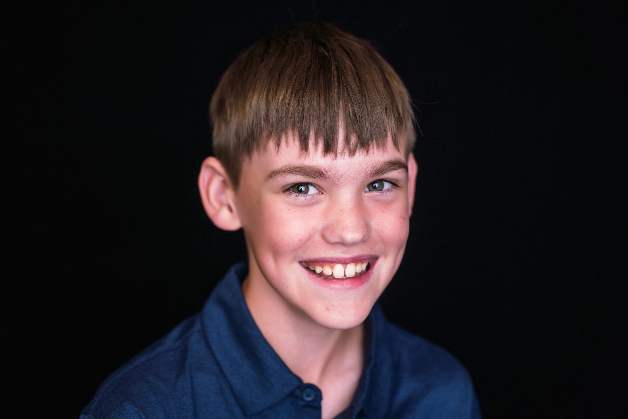 School Portrait of a elementary school boy on a black background