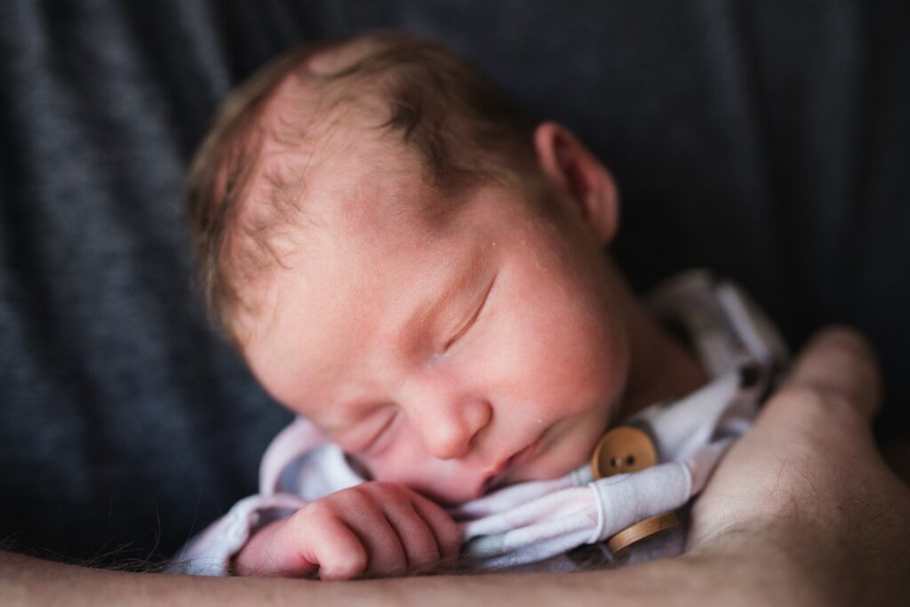 Portrait of baby girl in dad's arms during North Bend, Wa newborn portrait session