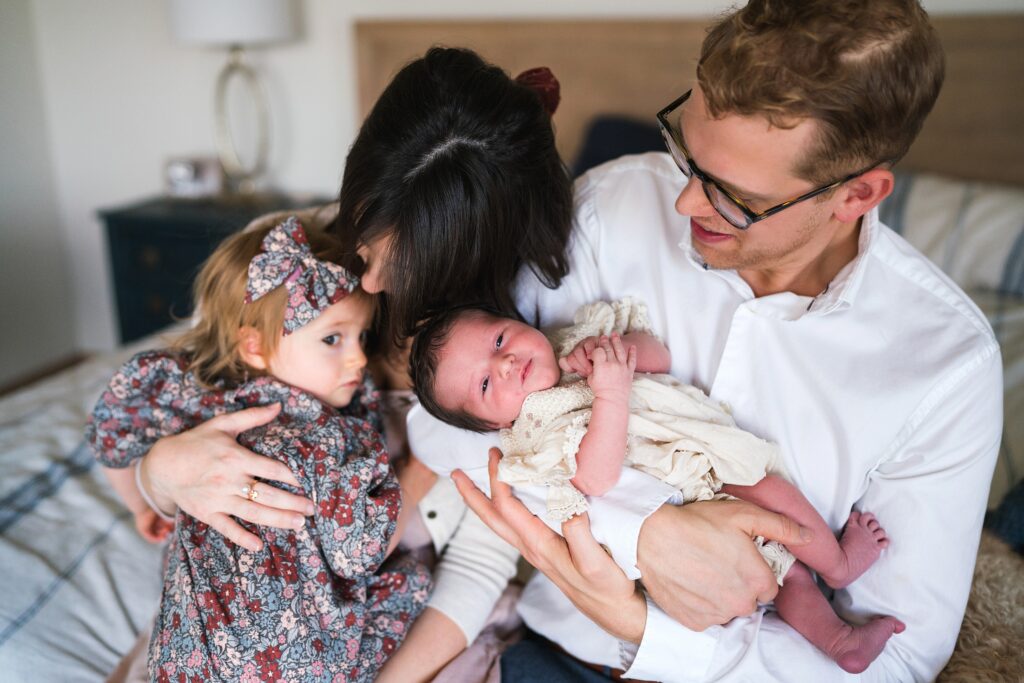 Family of four during Seattle newborn photography session, in-home lifestyle newborn portrait, pricing