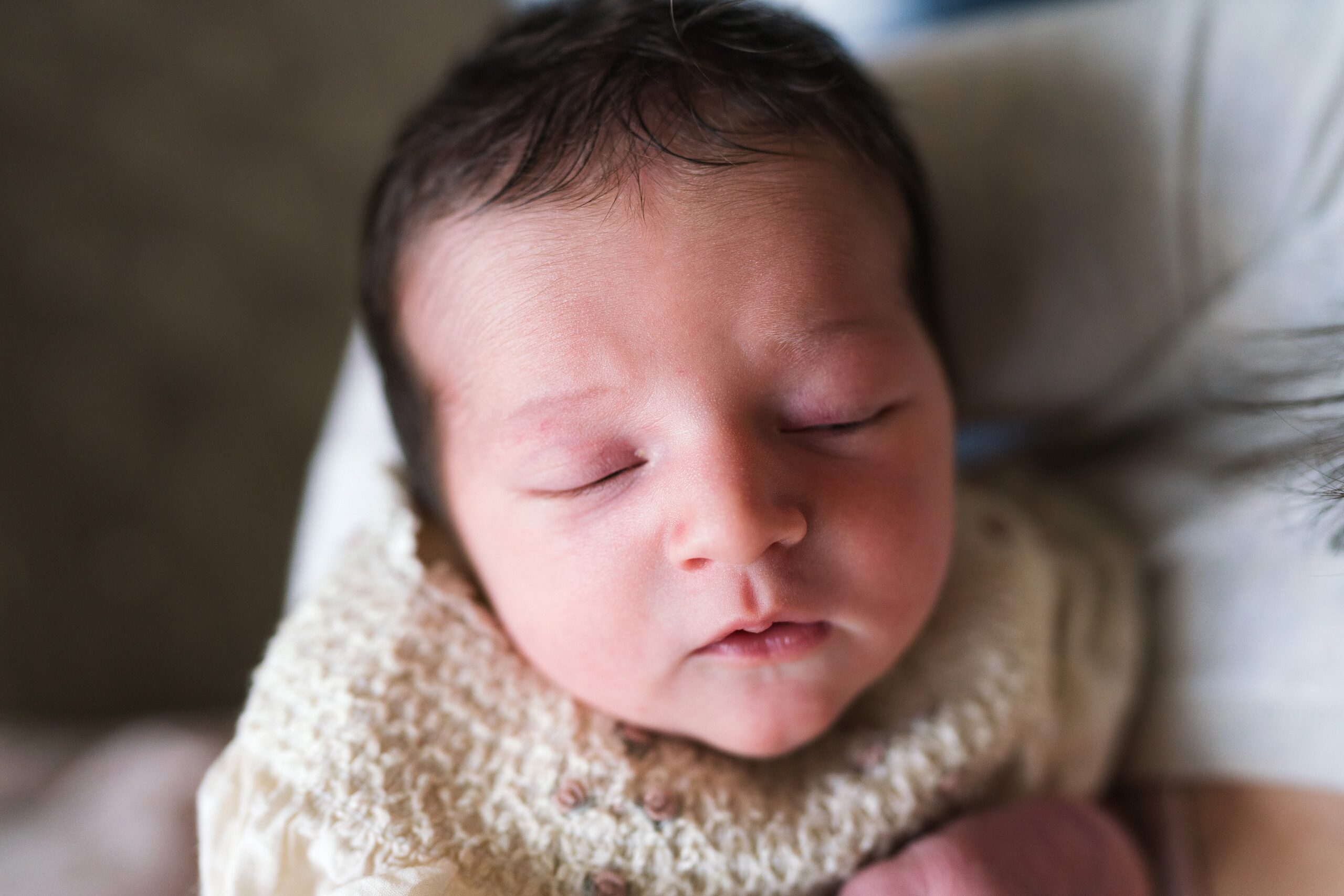 Newborn baby girl sleeping in mother's arms, Seattle newborn photography pricing