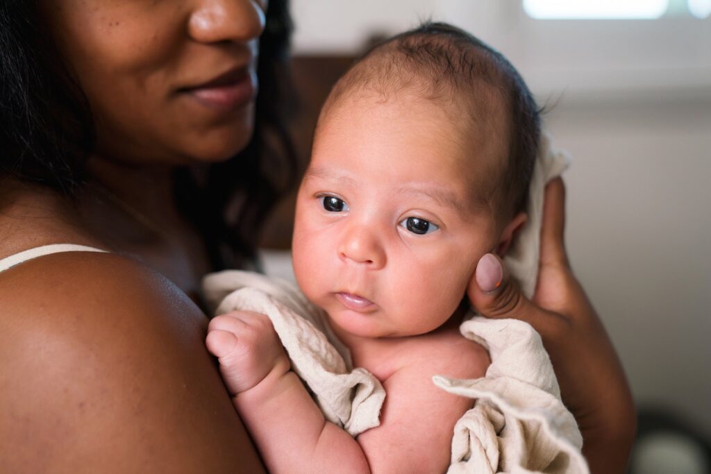 Issaquah Newborn Photographer photo of newborn baby against mom's chest